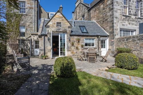 an external view of a stone house with a patio at No1 Apartments & Bedrooms St Andrews - St Mary's in St. Andrews