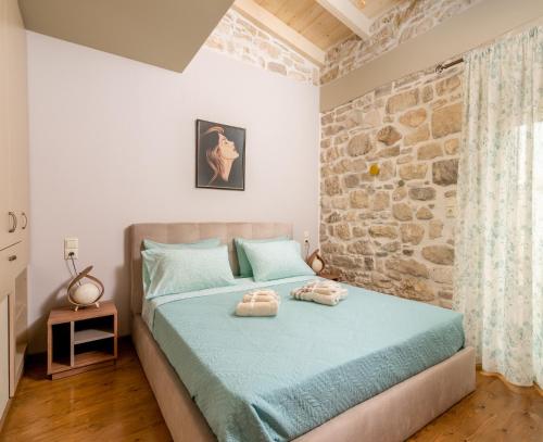 a bedroom with a bed with two towels on it at Oneiro Residence in Petrokefálion