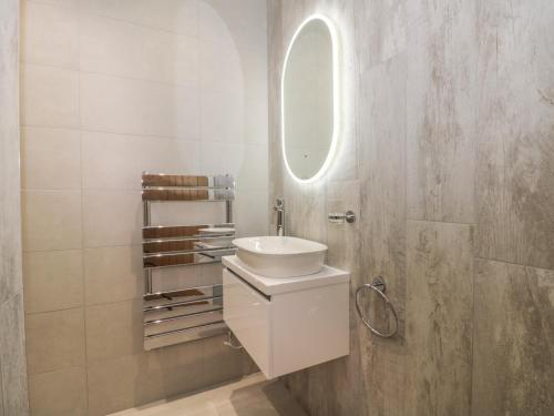 a white bathroom with a sink and a mirror at Laurel Farm in Malton