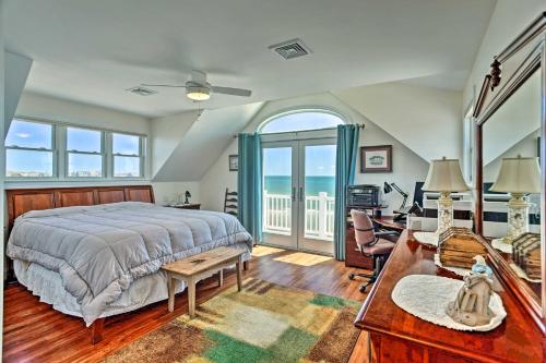 a bedroom with a bed and a balcony with the ocean at Sunny Beach House Getaway - Steps From Water! in Mattapoisett