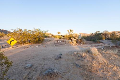 a road sign in the middle of a field at @ Marbella Lane - 10 Acres Oasis Desert Retreat! in Joshua Tree