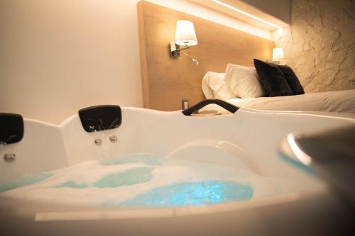 a bath tub in a room with a bed at Casa Bella Boutique Hotel in Antigua Guatemala