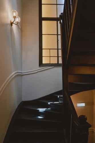 a stairway with a window and a black floor at MiraMe Athens Boutique Hotel in Athens