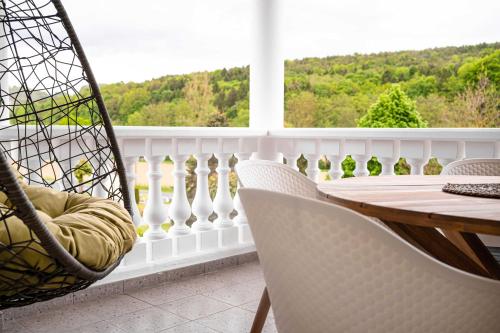 a porch with a hammock and a table and chairs at Villa Thermale in Unterlamm