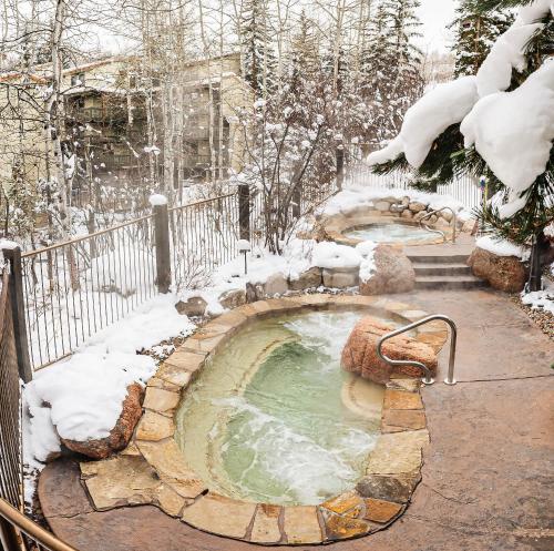 a hot tub in a snow covered yard at Laurelwood Condominiums 113 in Snowmass Village