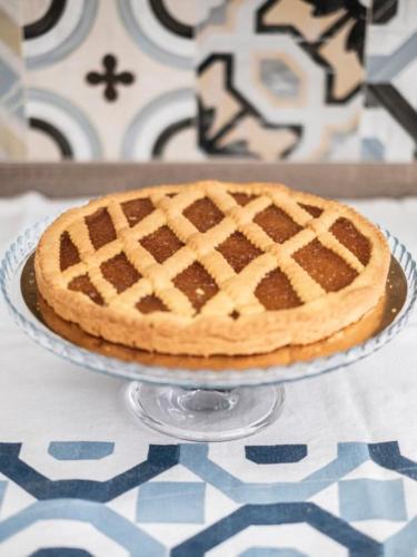 a pie sitting on a glass plate on a table at Hotel Lory in Forlì