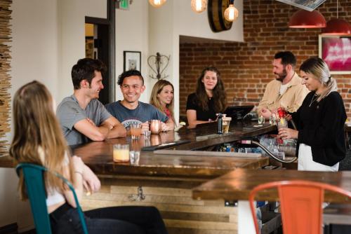 a group of people sitting at a bar at Hostel Fish in Denver