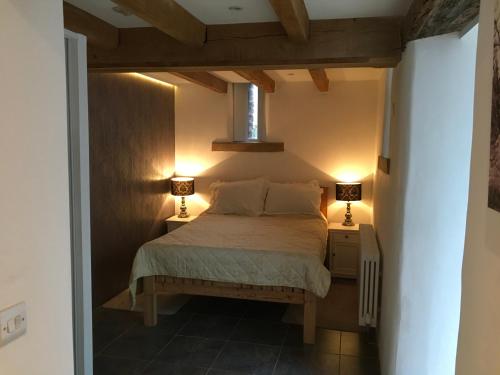 a bedroom with a bed with two lamps on it at The Bees Knees @ Redhill Grange in Monmouth
