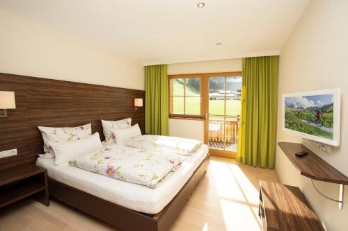 a bedroom with a large bed with a wooden headboard at Ferienwohnung "Mein Alpenjuwel" in Filzmoos