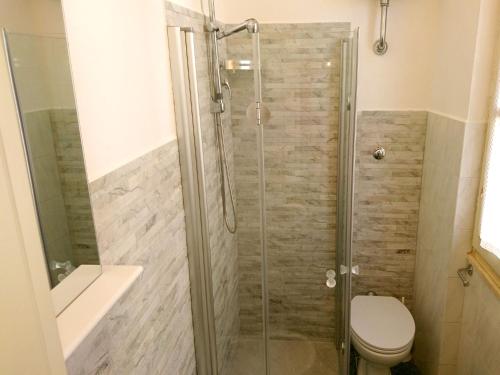 a bathroom with a shower with a toilet and a sink at Grottammare mon amour Ponente in Grottammare