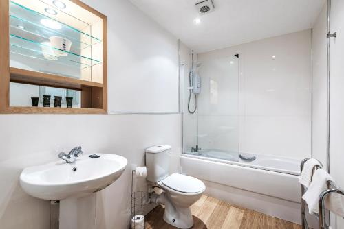 een badkamer met een toilet, een wastafel en een douche bij Merchants Gate York City Apartments in York
