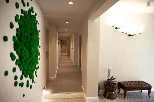 a hallway with a green wall in a house at Hotel Botanica in Belgrade