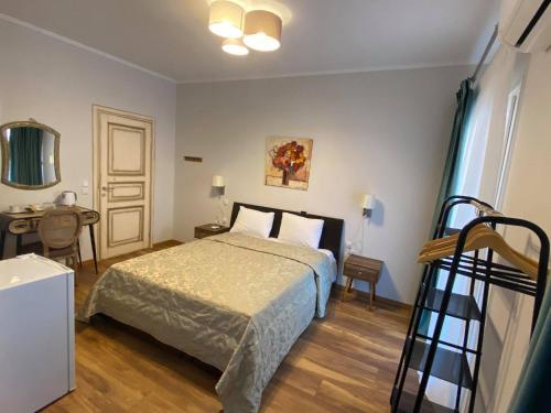 a bedroom with a bed and a desk and a table at Le Bijou Luxury Rooms & Suites in Veria