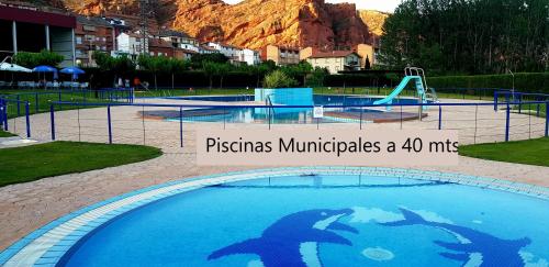 a swimming pool with a water slide in a park at Apartamentos Miradores del Isasa in Herce