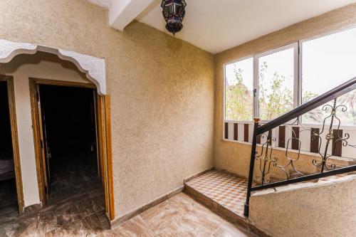 a room with a staircase and a window at Hotel De La Vallée in Aït Baha