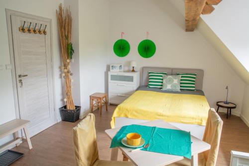 a bedroom with a bed and a table and chairs at Dom przy borowinie in Kołobrzeg
