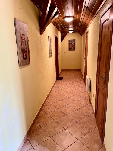 a hallway with a tile floor and a wooden ceiling at EDER- Penzion & Apartmány in Horní Planá