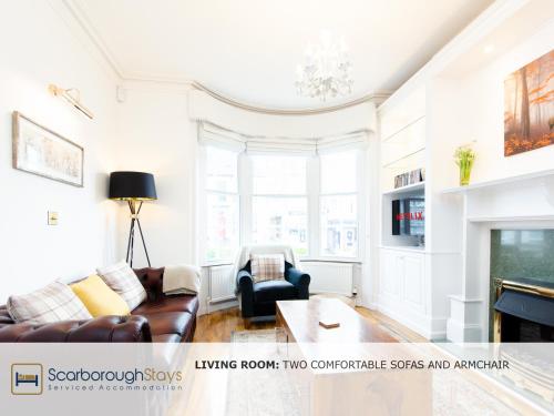 a living room with a couch and a table at Scarborough Central Townhouse in Scarborough