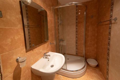 a bathroom with a sink and a shower and a toilet at Константин Асен 1 in Pomorie