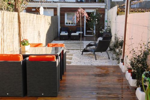 un patio con algunas sillas, una mesa y algunos alojamientos en Green Home, en Santiago de Compostela