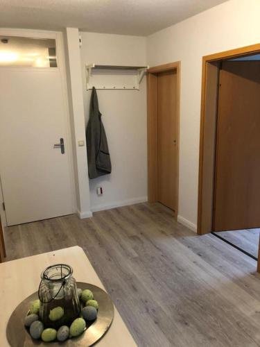 an empty room with a bowl of fruit on a table at MoMe Appartment in Groß Rönnau