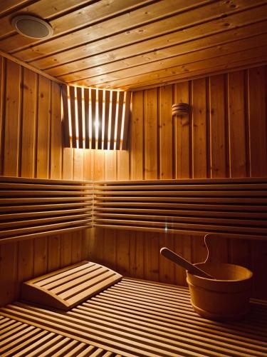 a sauna with a tub and a bowl in it at CASA ANKELI in Buşteni