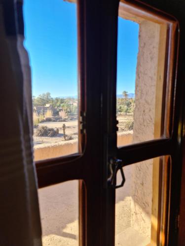 a view of a desert through an open door at Chez Laila in Skoura