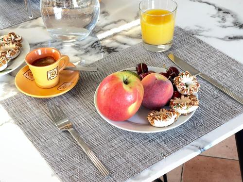 a plate of fruit and a cup of coffee on a table at La Casa Grande di Pantelleria in Pantelleria