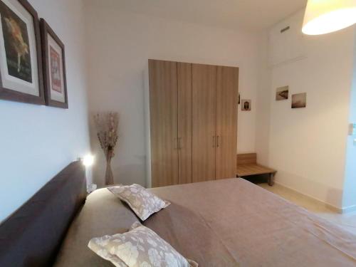 a bedroom with a large bed and a wooden cabinet at Villa Mirella Sea View Apartments in Positano