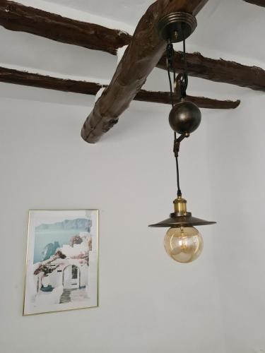 aendant light hanging from a ceiling with a picture at White Fish Mojacar in Mojácar