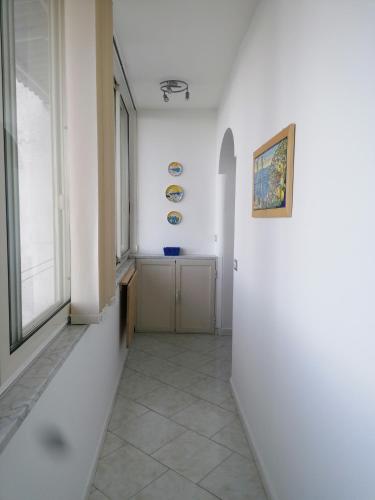 a hallway with white walls and a window at Villa Mirella Sea View Apartments in Positano