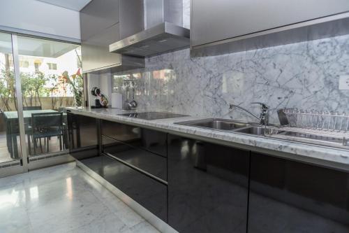 a kitchen with a sink and a counter top at Praia da Rocha Edifício Foz Palace t2 in Portimão
