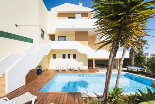 a villa with a swimming pool and palm trees at Villa Boho in Lagos