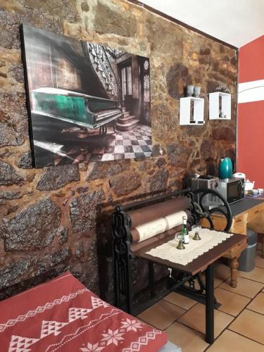 a room with a wall with a painting of a piano at Penzion Romance in Vyšší Brod