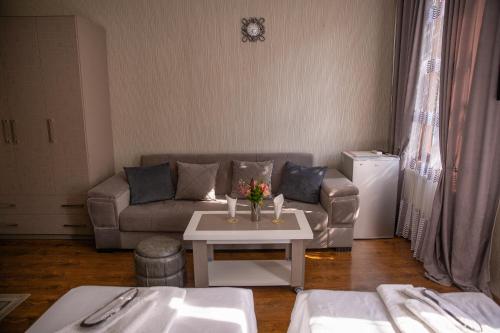 a living room with a couch and a table at Family Hotel Kolorit Old Tbilisi in Tbilisi City