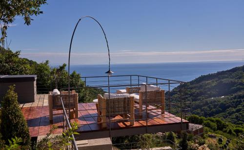 a balcony with chairs and a view of the ocean at Sunrise Garden Hills in Makrirrákhi
