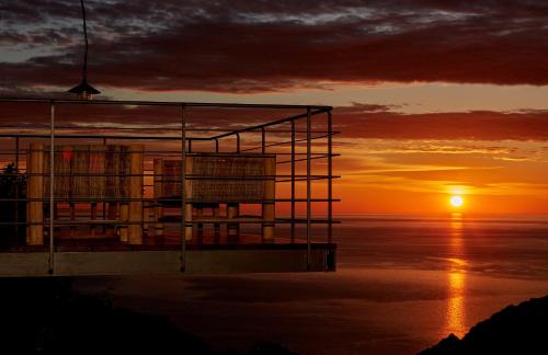 a view of the sun setting over the ocean at Sunrise Garden Hills in Makrirrákhi