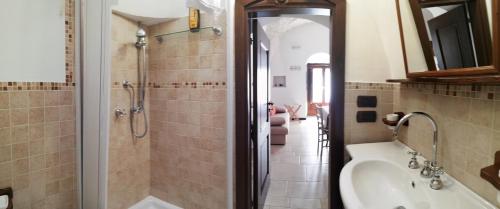 a bathroom with a shower and a sink at Luxury trulli Sabotino in Alberobello