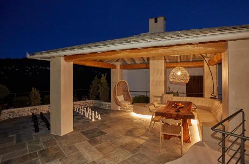 a pavilion with a table and chairs on a patio at Sunrise Garden Hills in Makrirrákhi