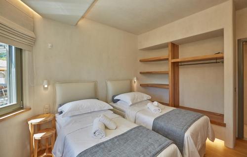 two beds sitting next to each other in a room at Sunrise Garden Hills in Makrirrákhi