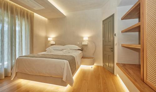 a bedroom with a bed and a large window at Sunrise Garden Hills in Makrirrákhi