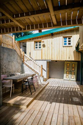 a wooden deck with a table and chairs on it at Apartment Aussee- Atelier Salzherrenhof- Küche, WLAN, Netflix in Bad Aussee