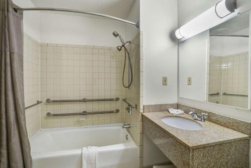 a bathroom with a tub and a sink and a shower at Motel 6-Montoursville, PA - Williamsport in Williamsport