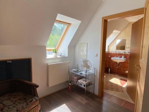 a attic room with a sink and a bathroom at Piraten Oase in Tribohm