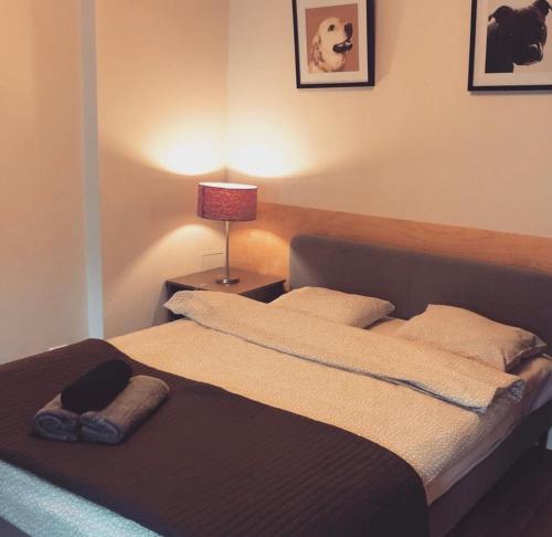 a bedroom with a bed with a lamp on a table at Good JuJu Studio Apartment in the Old Town in Poznań