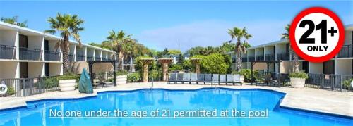 a swimming pool in front of a hotel at Royal Holiday Beach Resort in Biloxi
