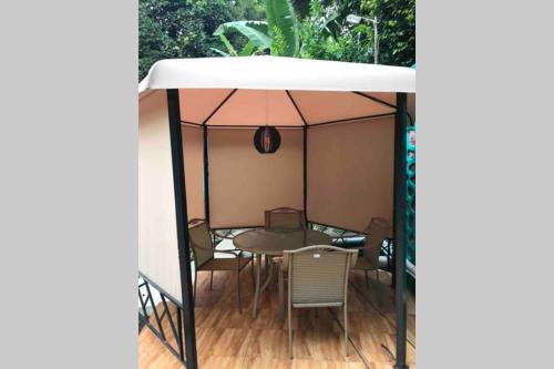 a gazebo with a table and chairs under it at Private Villa Dekke Boru, Bogor in Bogor