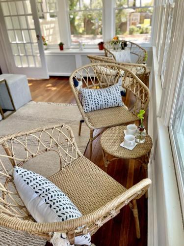 two wicker chairs and a table on a porch at Buttonwood Boutique Hotel in West Cape May