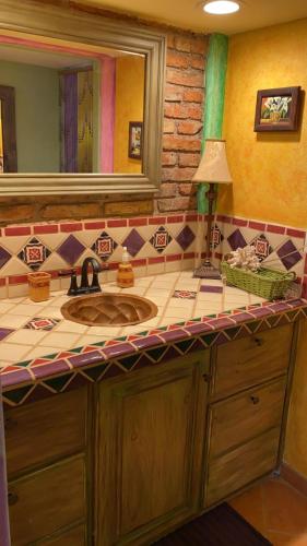 a bathroom with a sink and a mirror at Loft with rooftop deck in the Malecon - Unit #206 in Puerto Peñasco