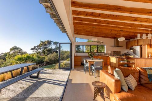 an open living room and kitchen of a house at Karu ō te Kiwi in Pakawau
